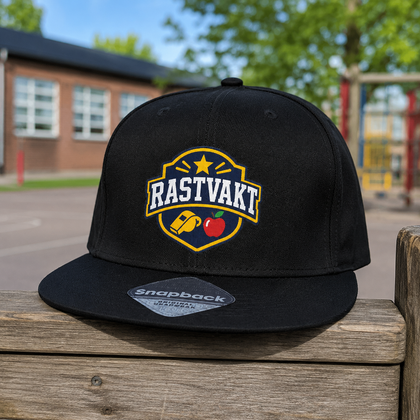 Svart rastvaktskeps med tydligt RASTVAKT-tryck för lärare och skolpersonal